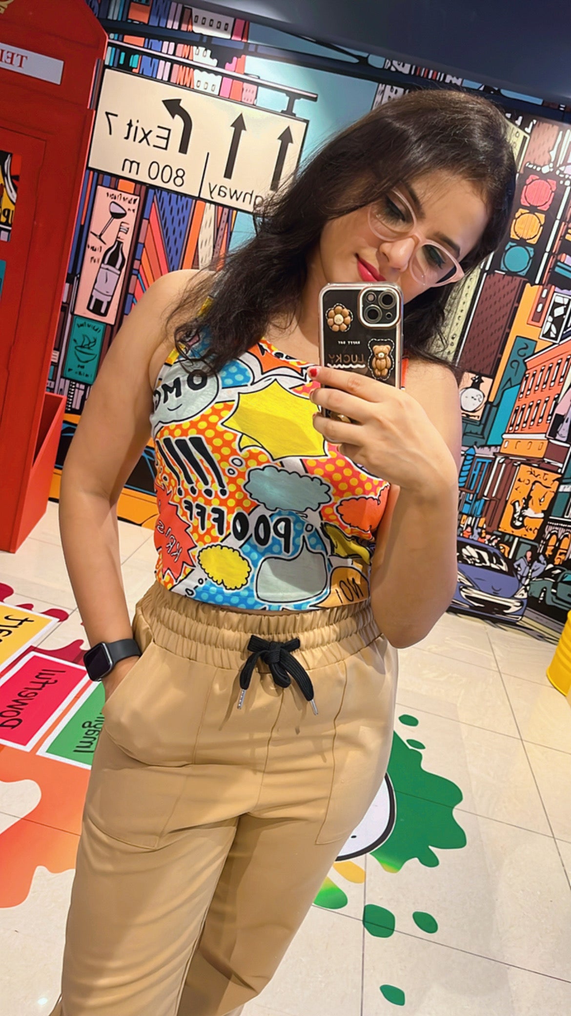 A woman wearing the Poof yellow crop tank top from The Edi Archive’s Ctrl+Me Collection – playful, bold, and cartoon-core cute.