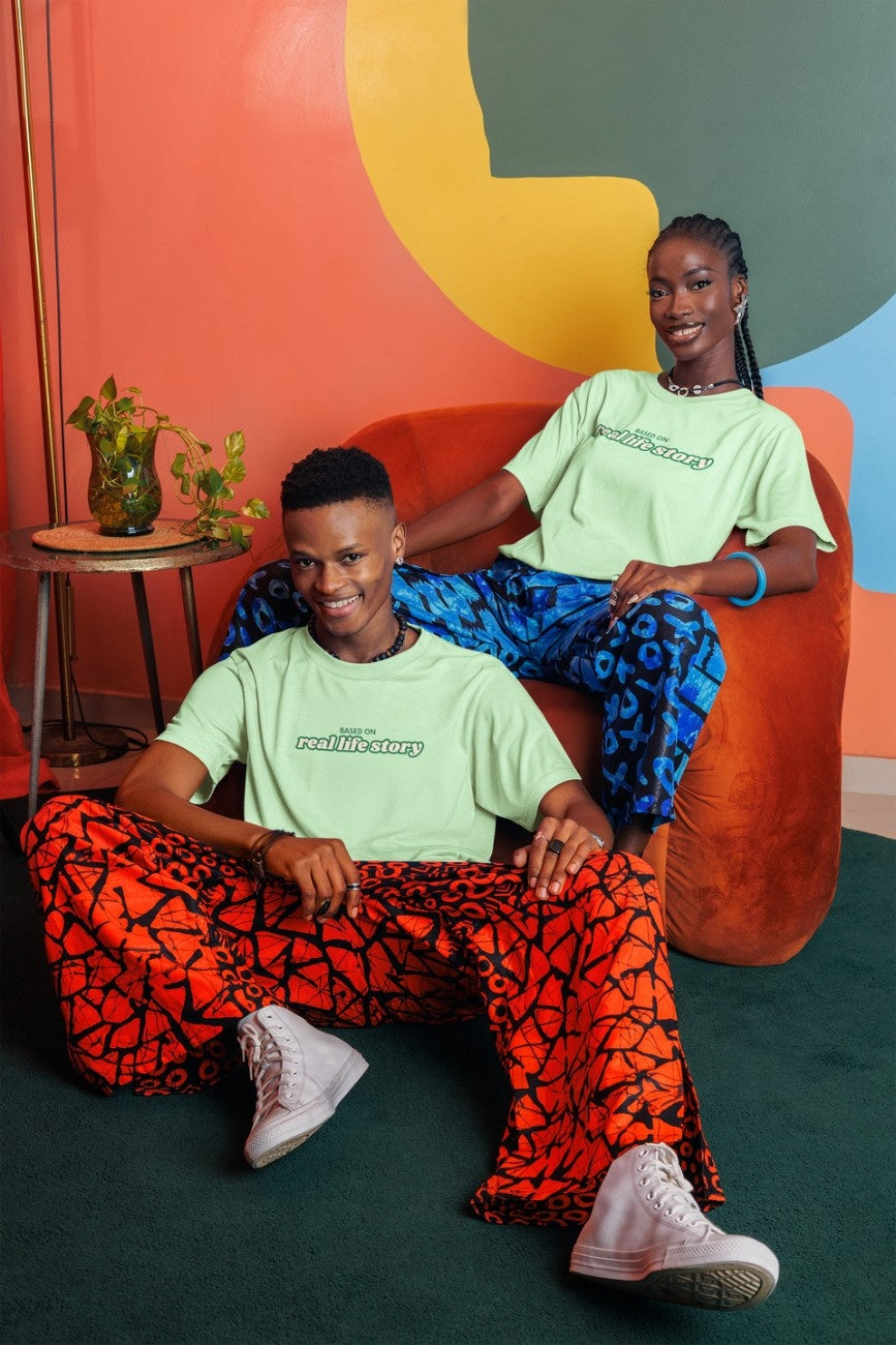 A man and a woman wearing 'Based On Real Life Story Unisex Oversized T-Shirt' from The Edi Archive - Ctrl+Me Collection