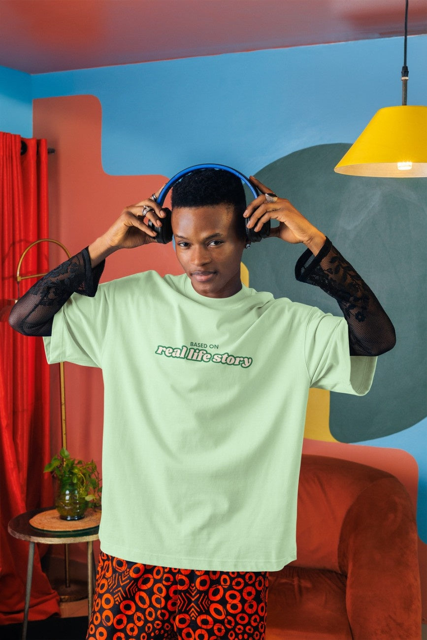 A man and a woman wearing 'Based On Real Life Story Unisex Oversized T-Shirt' from The Edi Archive - Ctrl+Me Collection