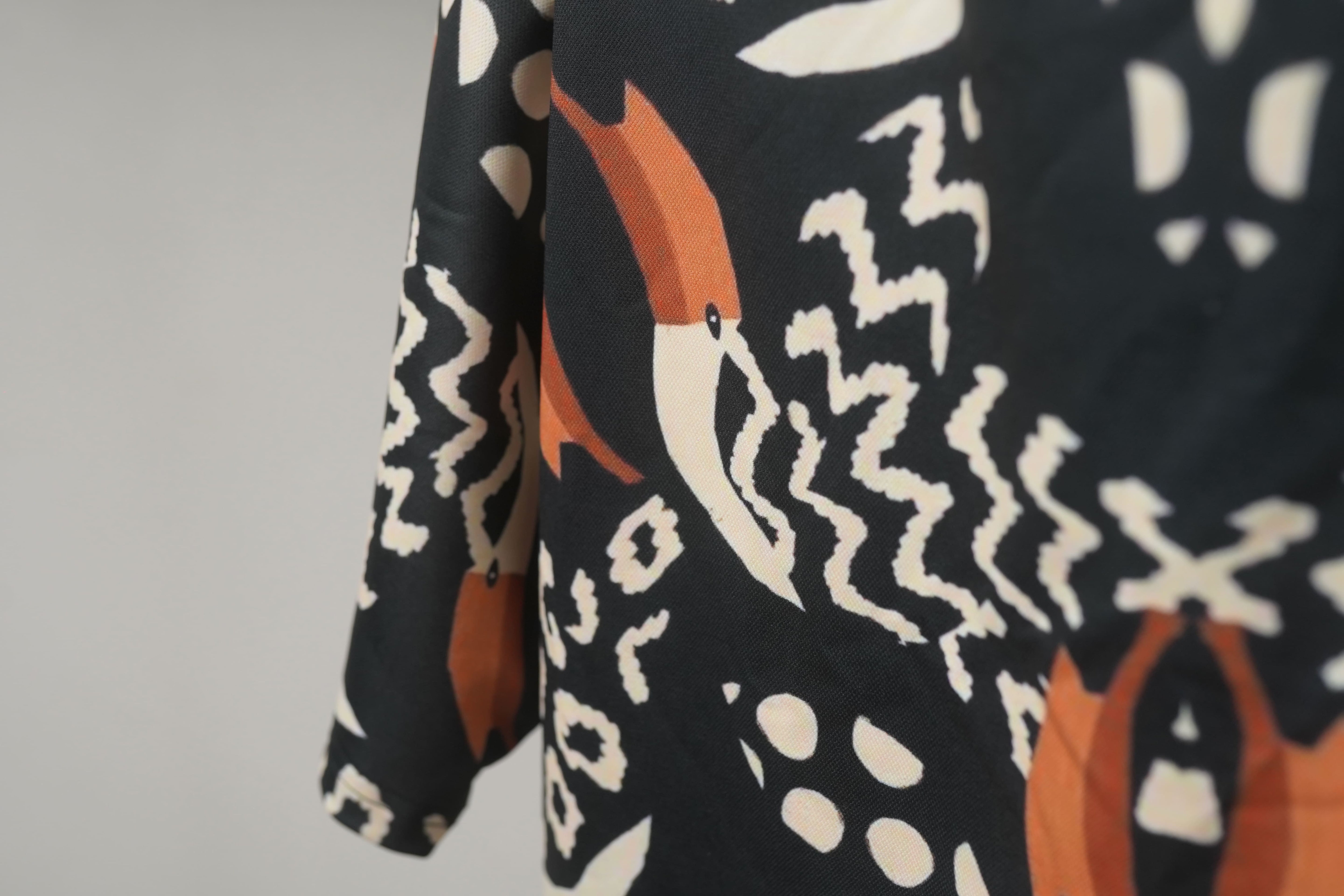 Macro image of  Pelican Breeze Unisex Oversized T-Shirt from The Edi Archive, fabric showing lightweight shiny drifit texture