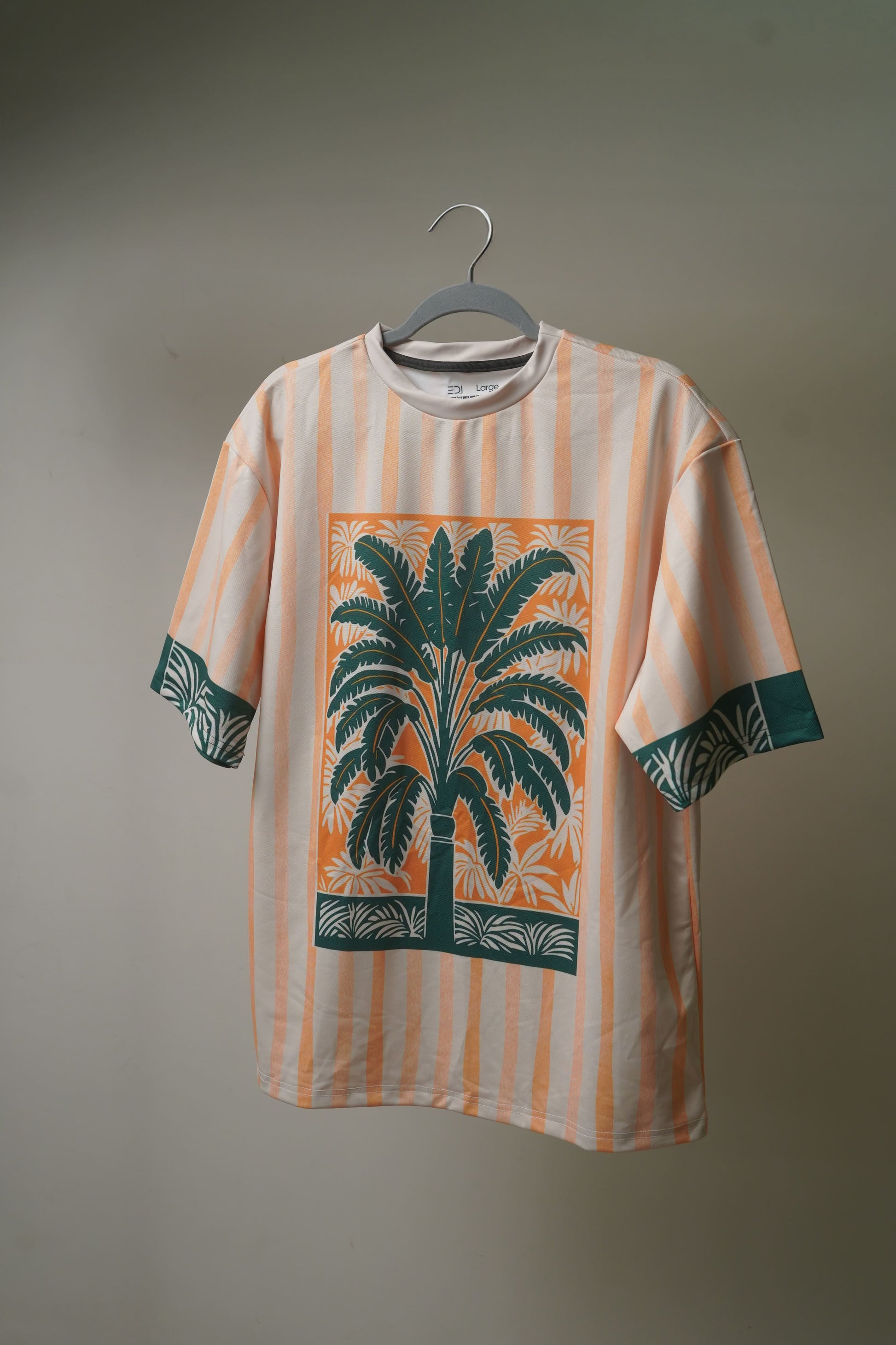 Front view of Azure Palms Unisex Oversized t-shirt from The Edi Archive,  featuring full tropical print and oversized fit