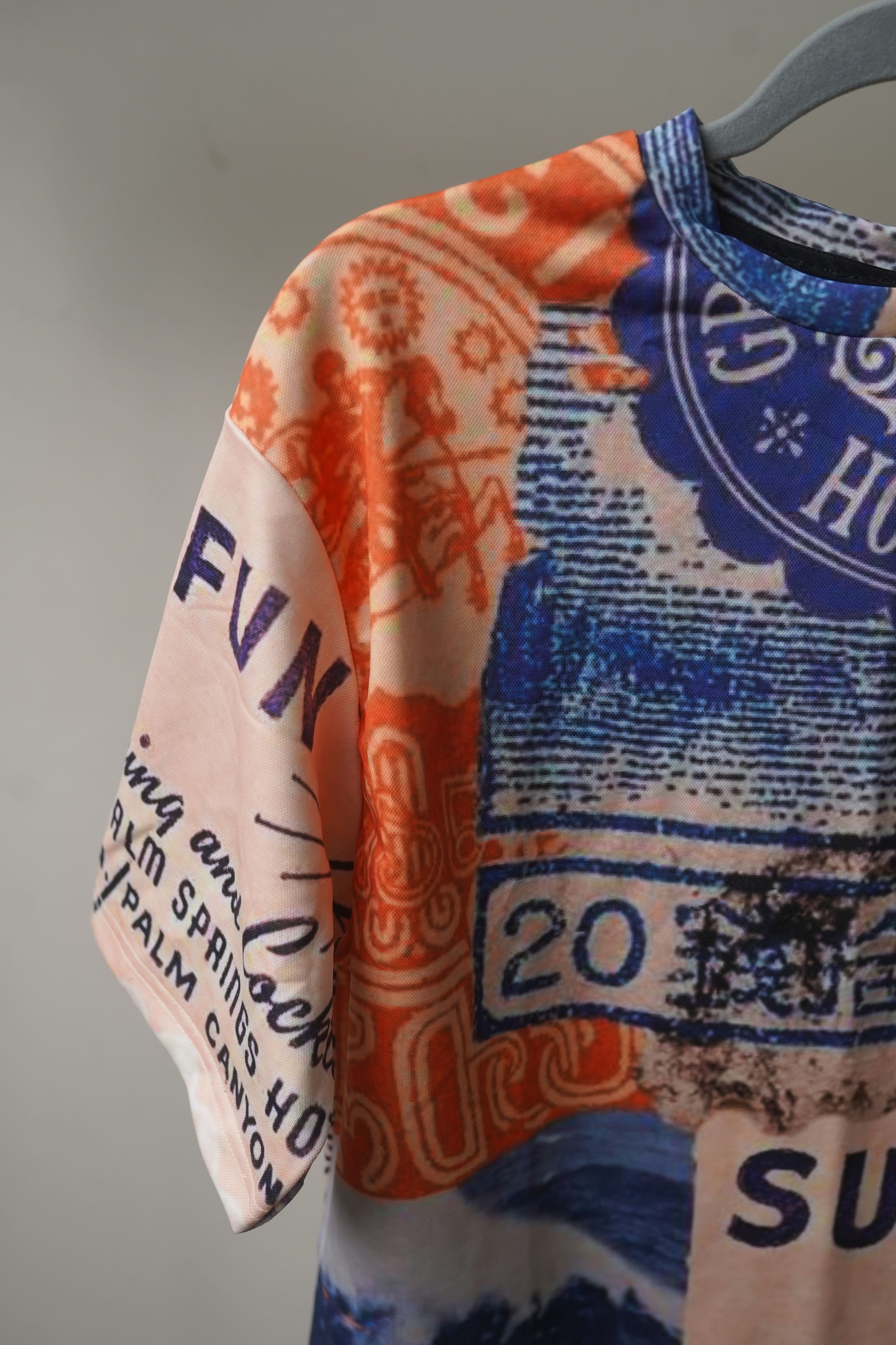 Sun Swim Fun Unisex Oversized T-Shirt from The Edi Archive, with bright tropical-themed all-over print in lightweight drifit fabric sleeve details