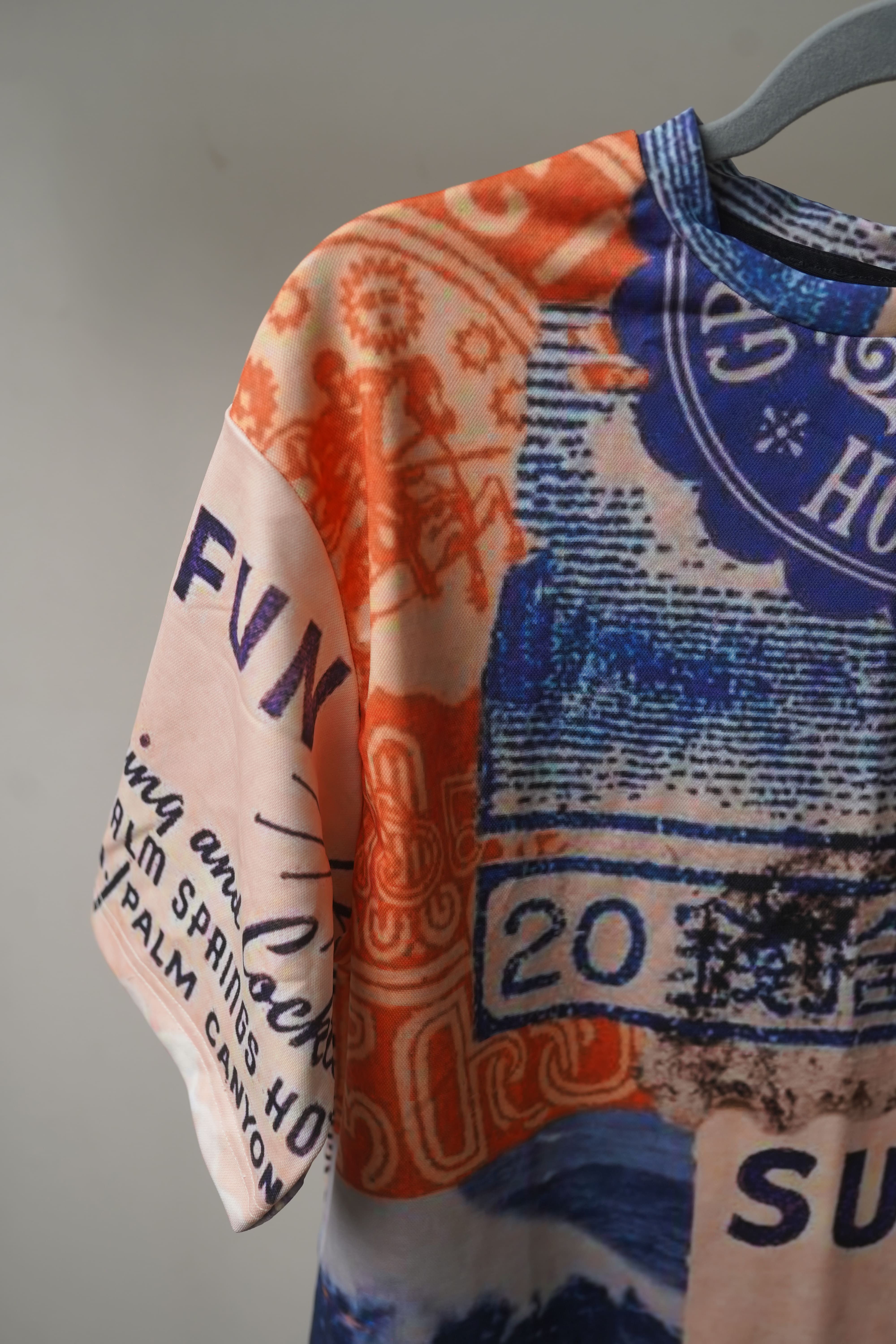 Sun Swim Fun Unisex Oversized T-Shirt from The Edi Archive, with bright tropical-themed all-over print in lightweight drifit fabric sleeve details