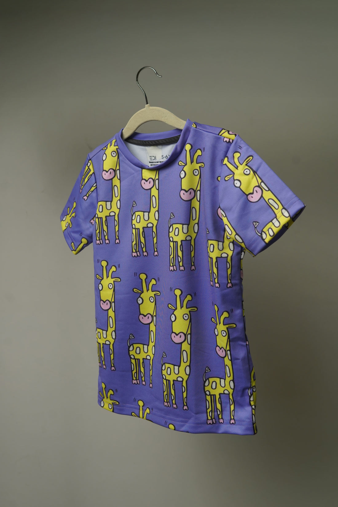 Close-up of Happy Giraffe Kids T-shirt print showing fine drifit texture and graphic details
