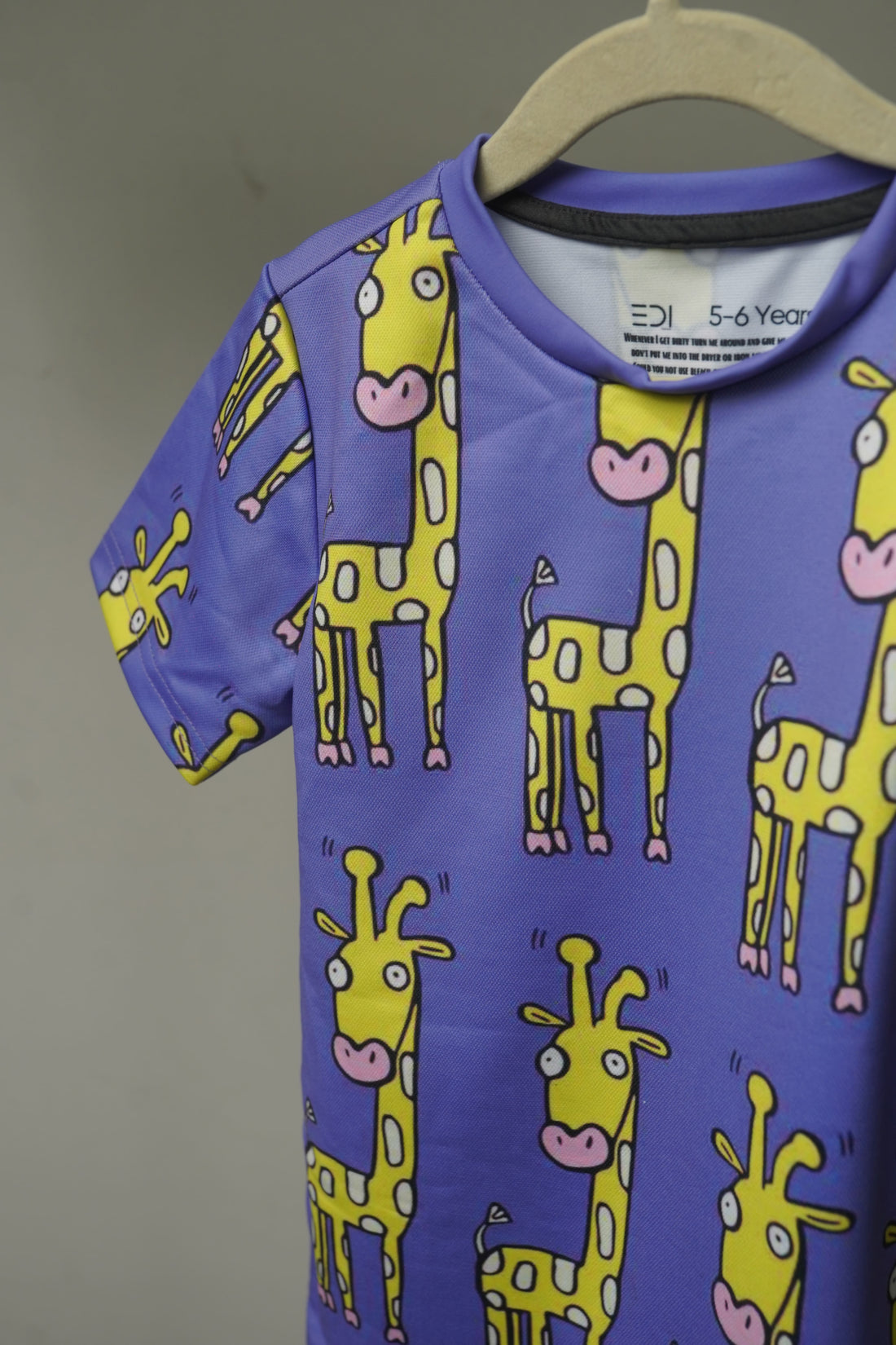 Close-up of Happy Giraffe Kids T-shirt print showing fine drifit texture and graphic details