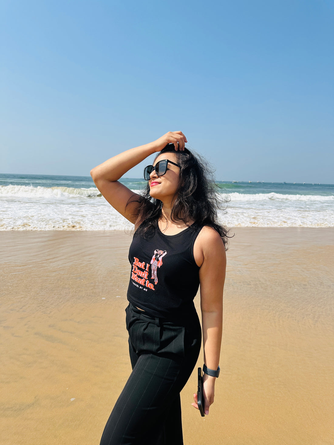 A woman wearing the black But I Don’t Want To crop tank top from The Edi Archive’s Ctrl+Me Collection – bold, minimalist, and sassy.