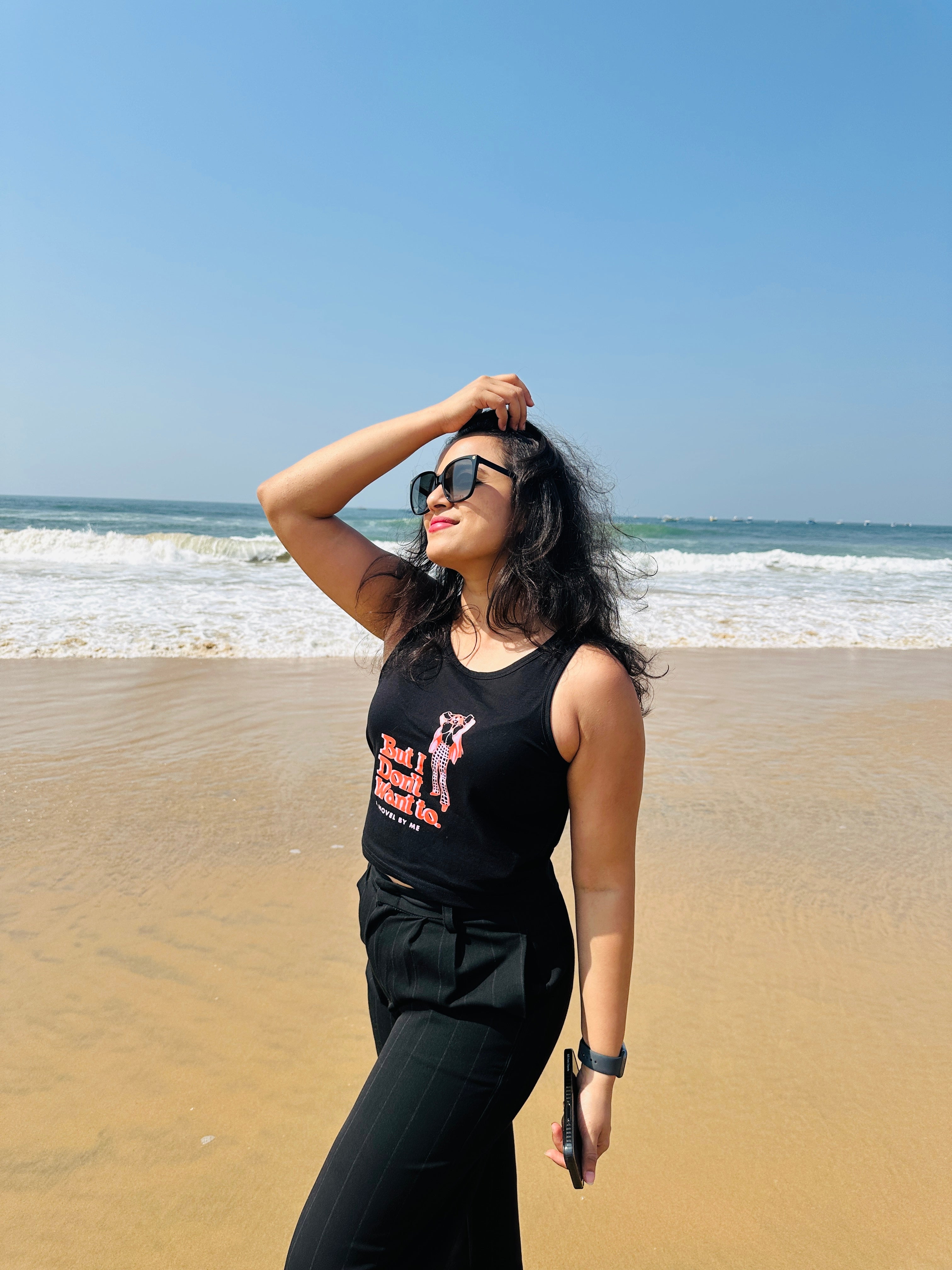 A woman wearing the black But I Don’t Want To crop tank top from The Edi Archive’s Ctrl+Me Collection – bold, minimalist, and sassy.