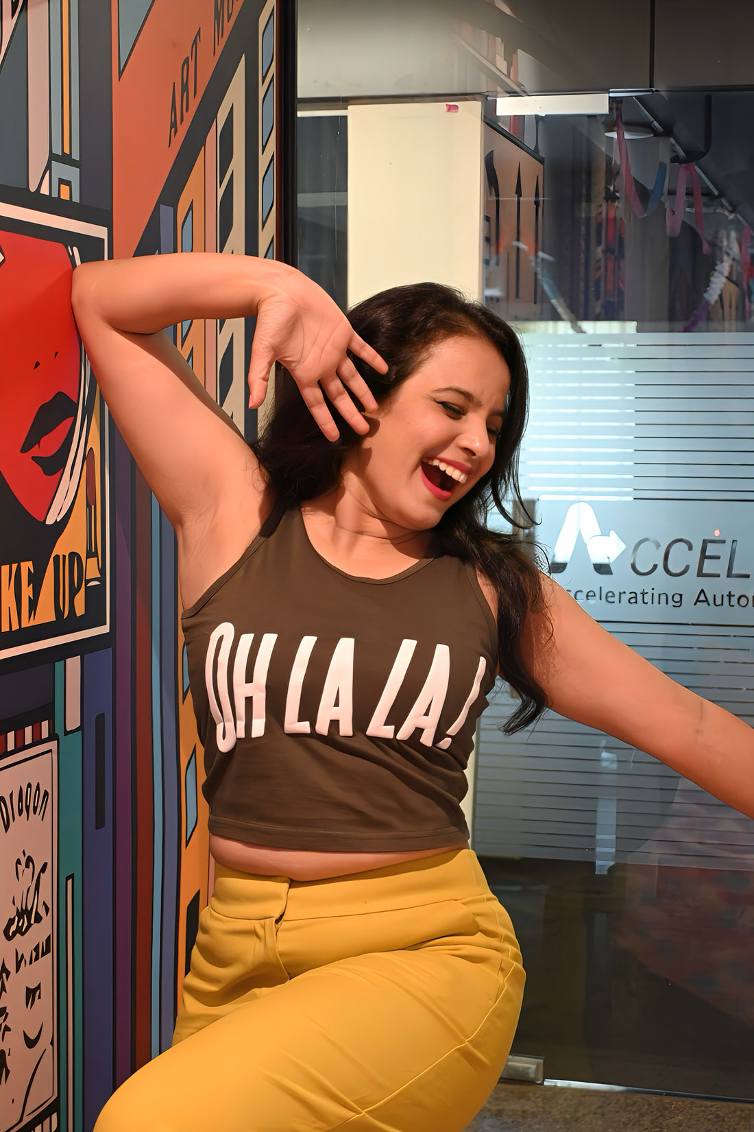 A woman wearing the Oh La La olive green crop tank top from The Edi Archive with puff print – flirty French charm in cotton.