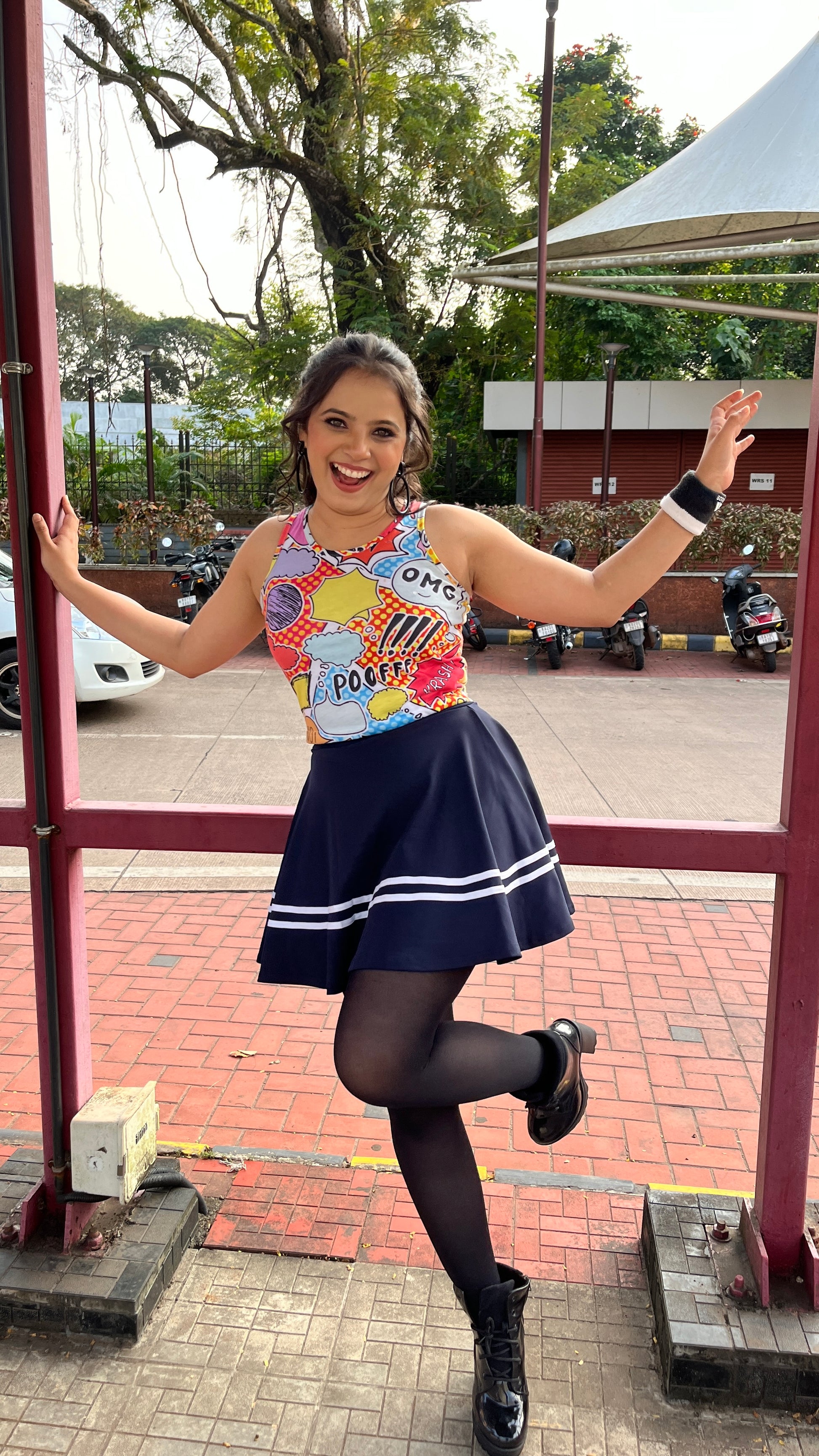 A woman wearing the Poof yellow crop tank top from The Edi Archive’s Ctrl+Me Collection – playful, bold, and cartoon-core cute.