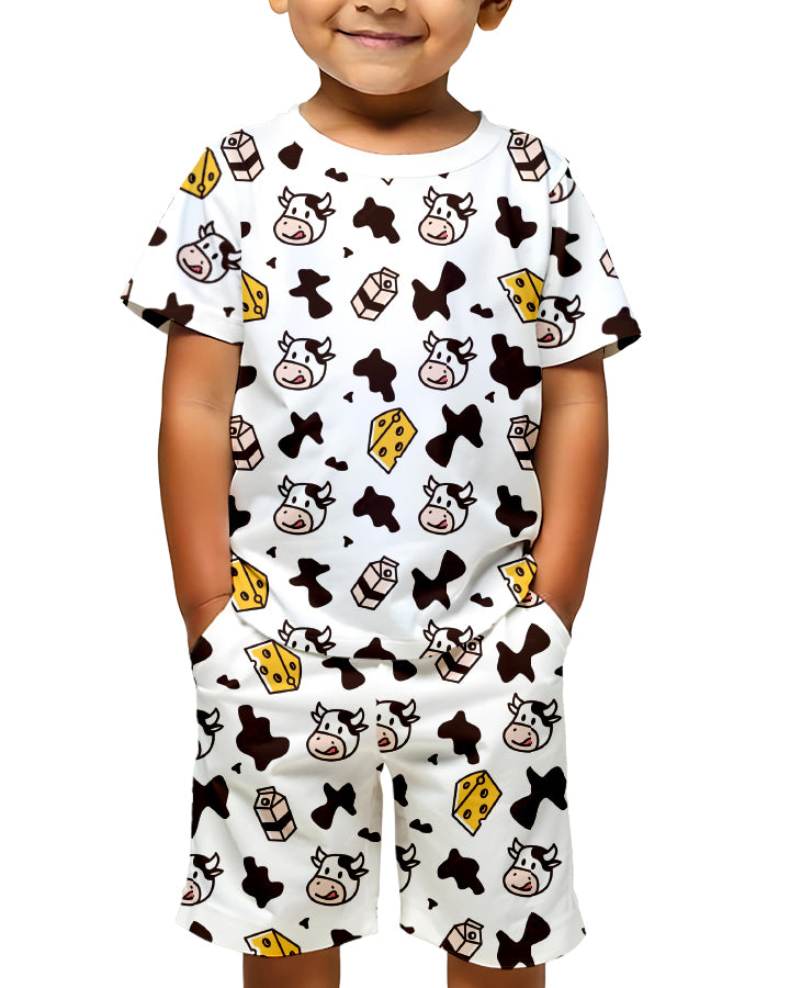 Child wearing Moo Baby Kids Co-Ords Set front view with bold cow print T-shirt and shorts