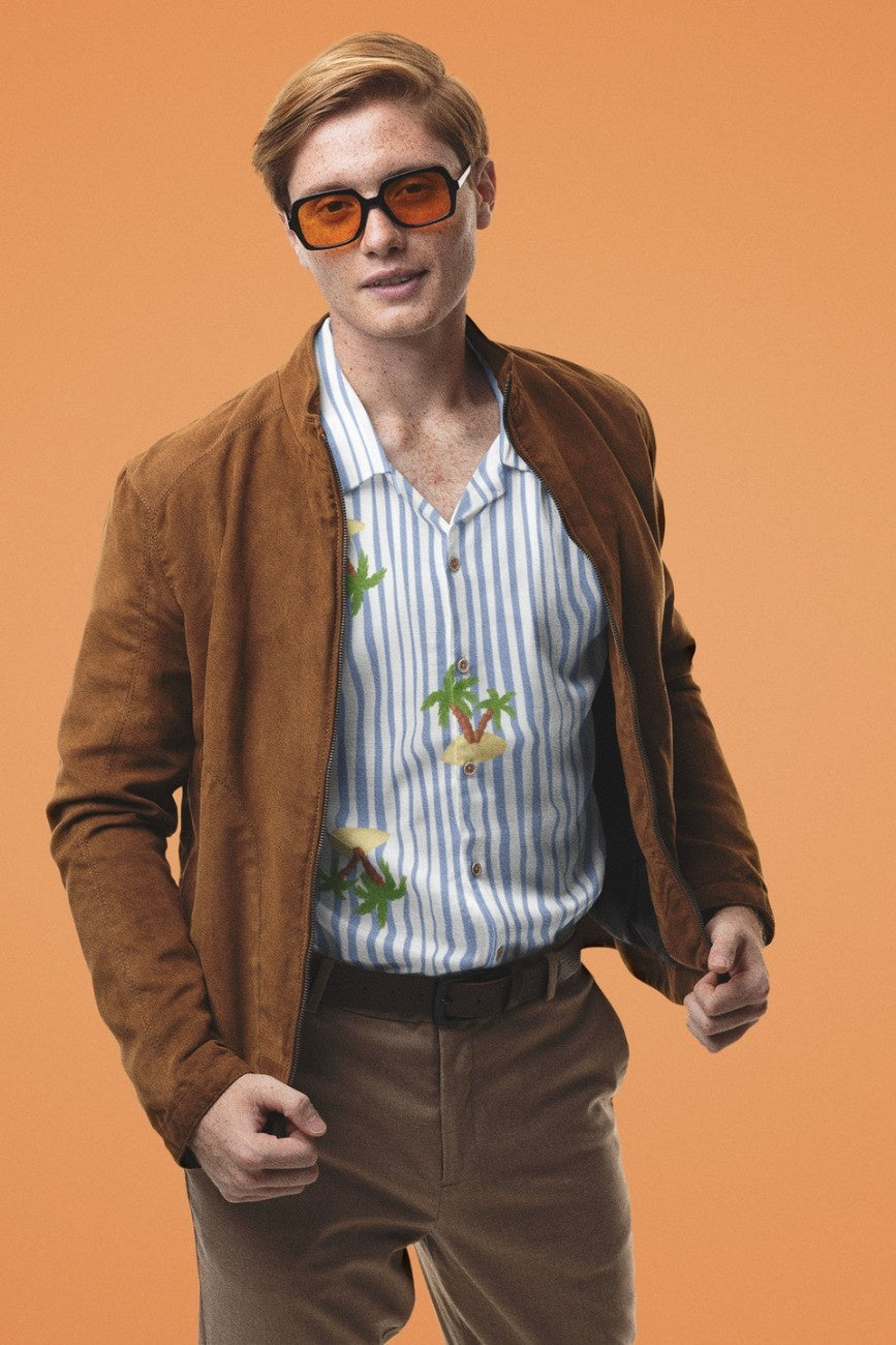 Man wearing Nature's Paradise Men's Hawaiian Shirt from The Edi Archive, holding a glass.