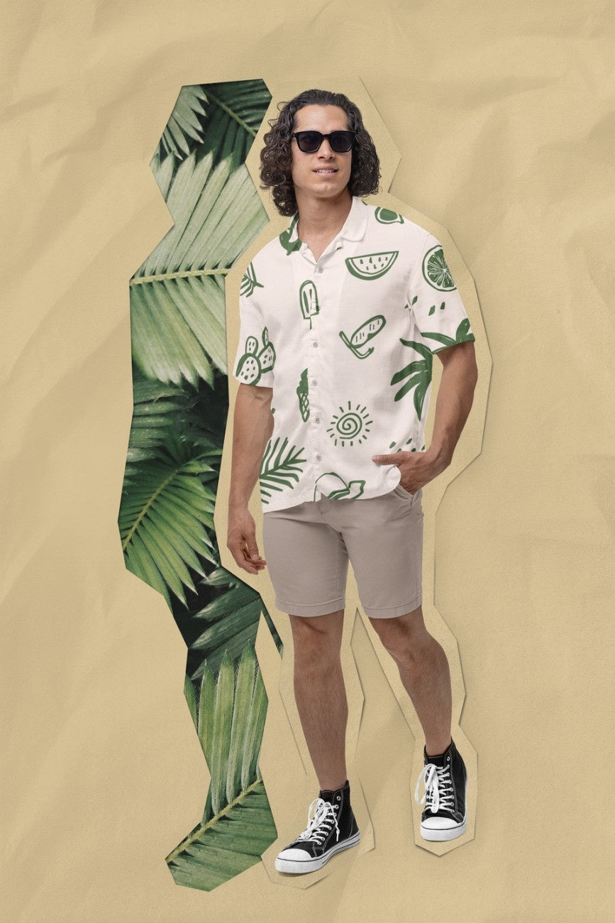 Man wearing a Summer Vacation Hawaiian Shirt from Tropical Drops from The Edi Archive, and shorts with tropical leaves on a beige background