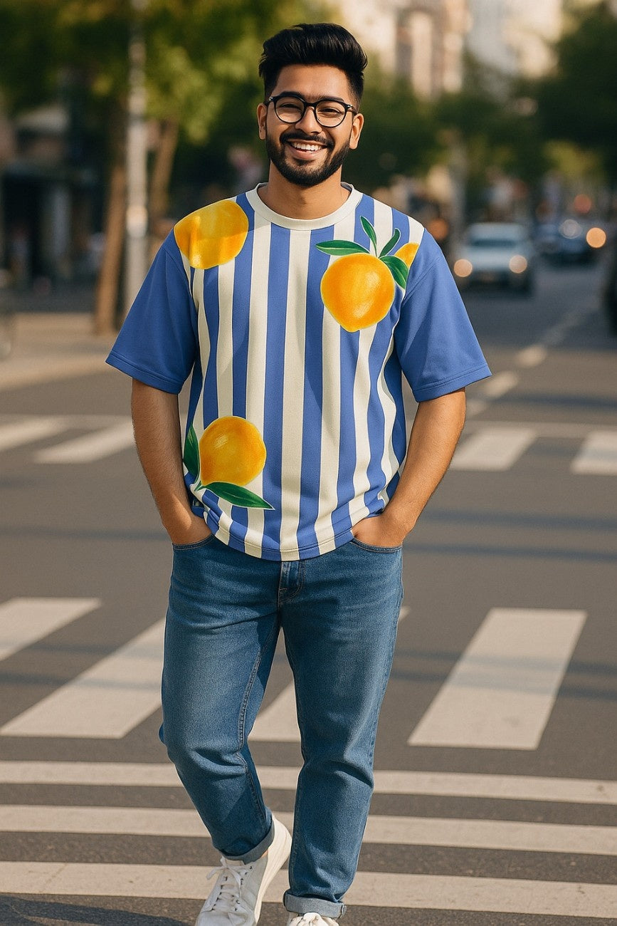 Man wearing Zesty Blue Unisex Oversized T-Shirt from The Edi Archive, on a city street.