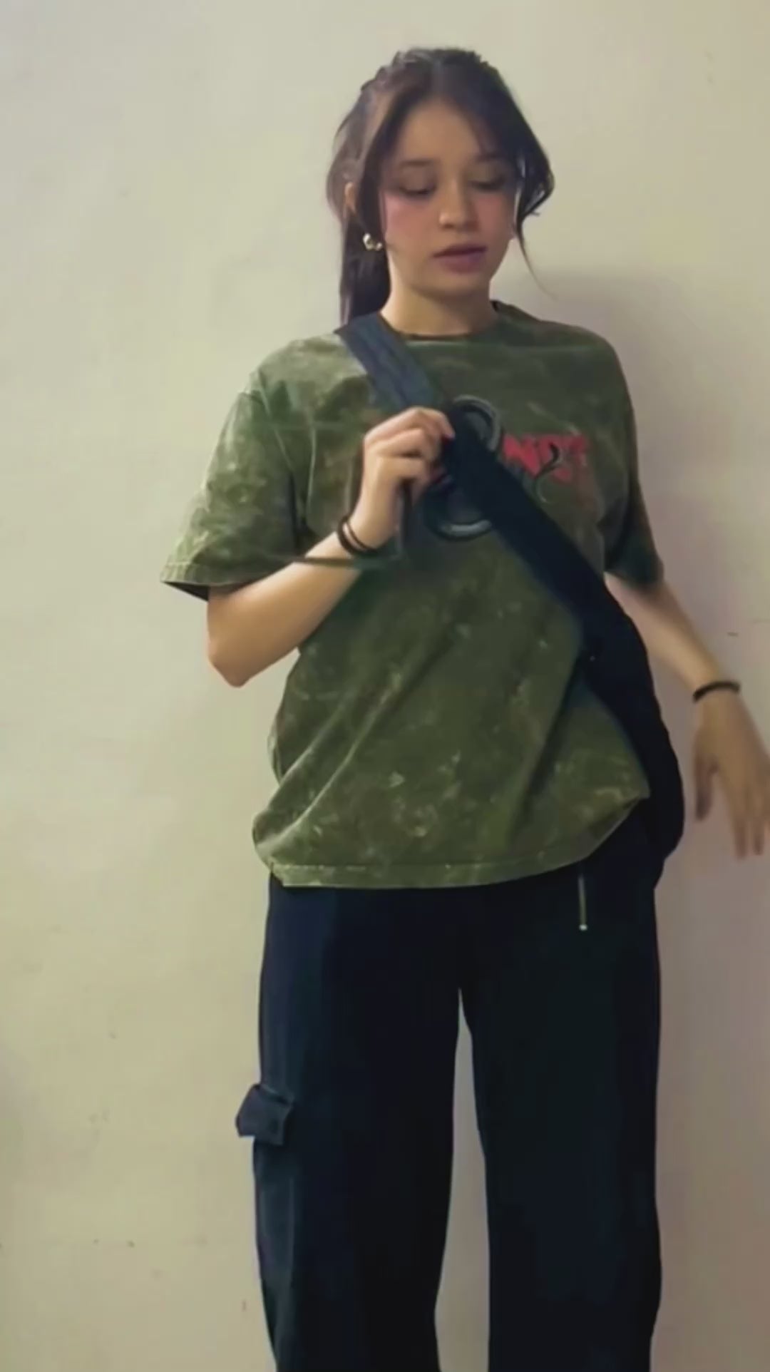 A cute girl wearing Instinct Unisex Oversized Stone Washed T-Shirt by The Edi Archive