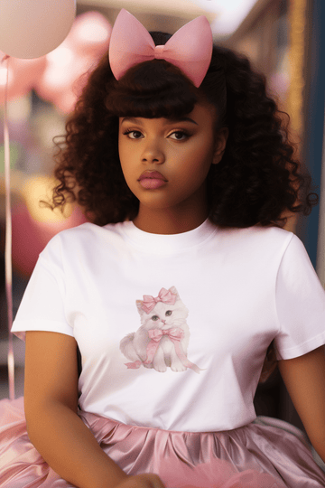 Girl wearing white cotton Pretty Please women’s t-shirt from The Edi Archive, featuring a cute coquette cat, styled in soft, Pinterest-core aesthetic.