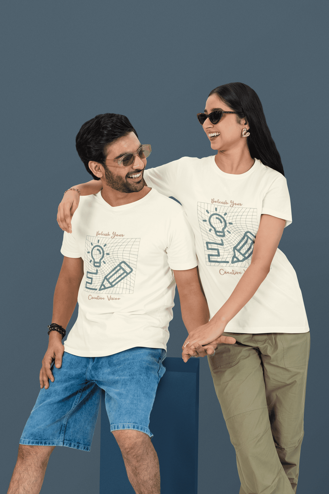 Two people wearing matching off-white t-shirts with your custom graphic designs by The Edi Archive