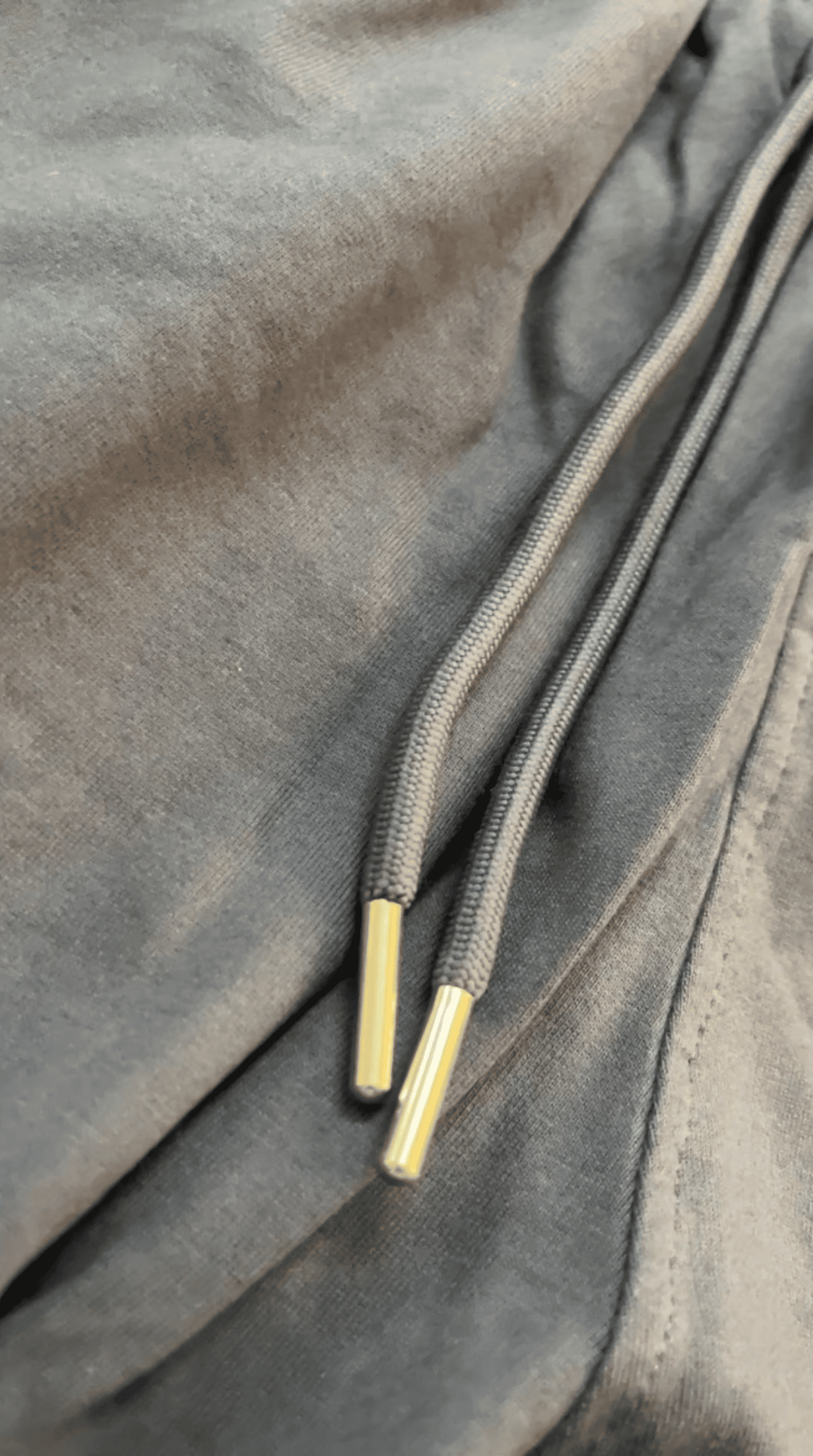 Close-up of the lace with silver metal tips of the Comfy Chaos Unisex Sweat Pants from The Edi Archive