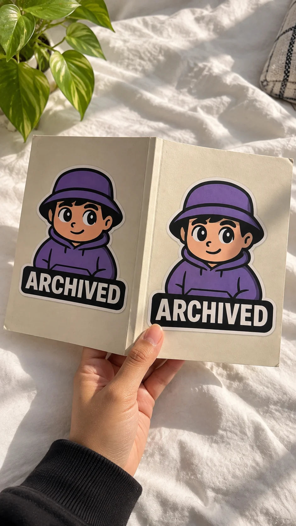 Archived A5 Notebook by The Edi Archive from The Side Quest Collection, front and back of the notebook featuring purple Archived artwork held against a white background