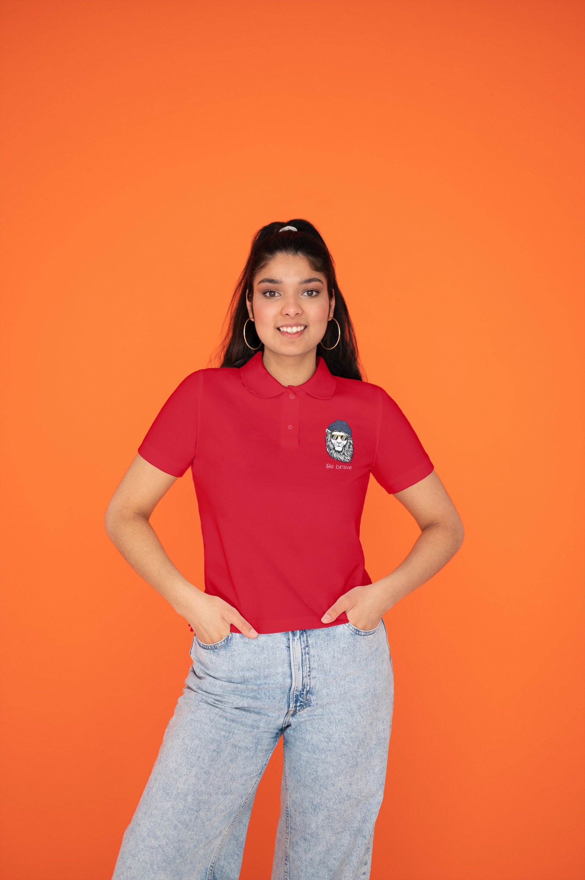 Woman wearing The Edi Archive’s ‘Be Brave’ red polo T-shirt from the CTRL+ME collection — fierce, fun, and effortlessly cool.