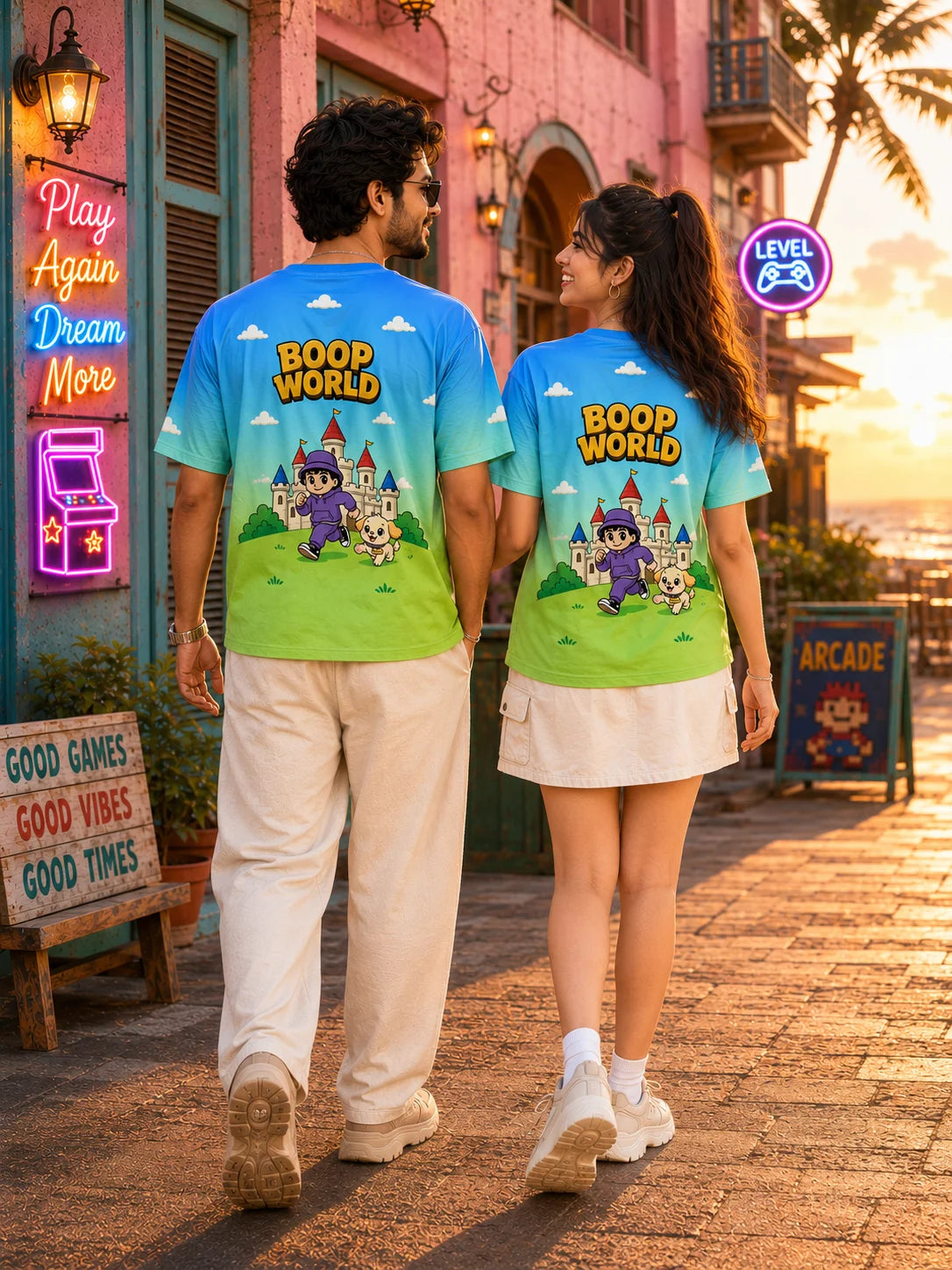 Couple wearing matching Boop World all over print unisex t-shirts with a retro game world graphic, close detail of the front print, Boop World Unisex T-Shirt, Boop Squad Collection, The Edi Archive