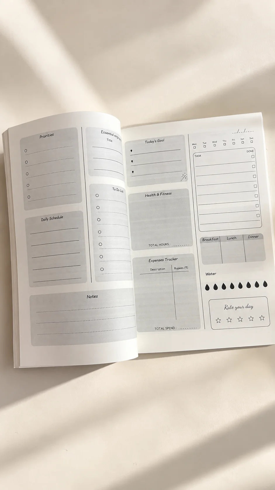 Inside pages of Dear Diary A5 daily planner showing sections for priorities, goals, to-do lists, schedule, health and fitness, expenses, meals, water tracking and daily reflection, The Side Quest by The Edi Archive