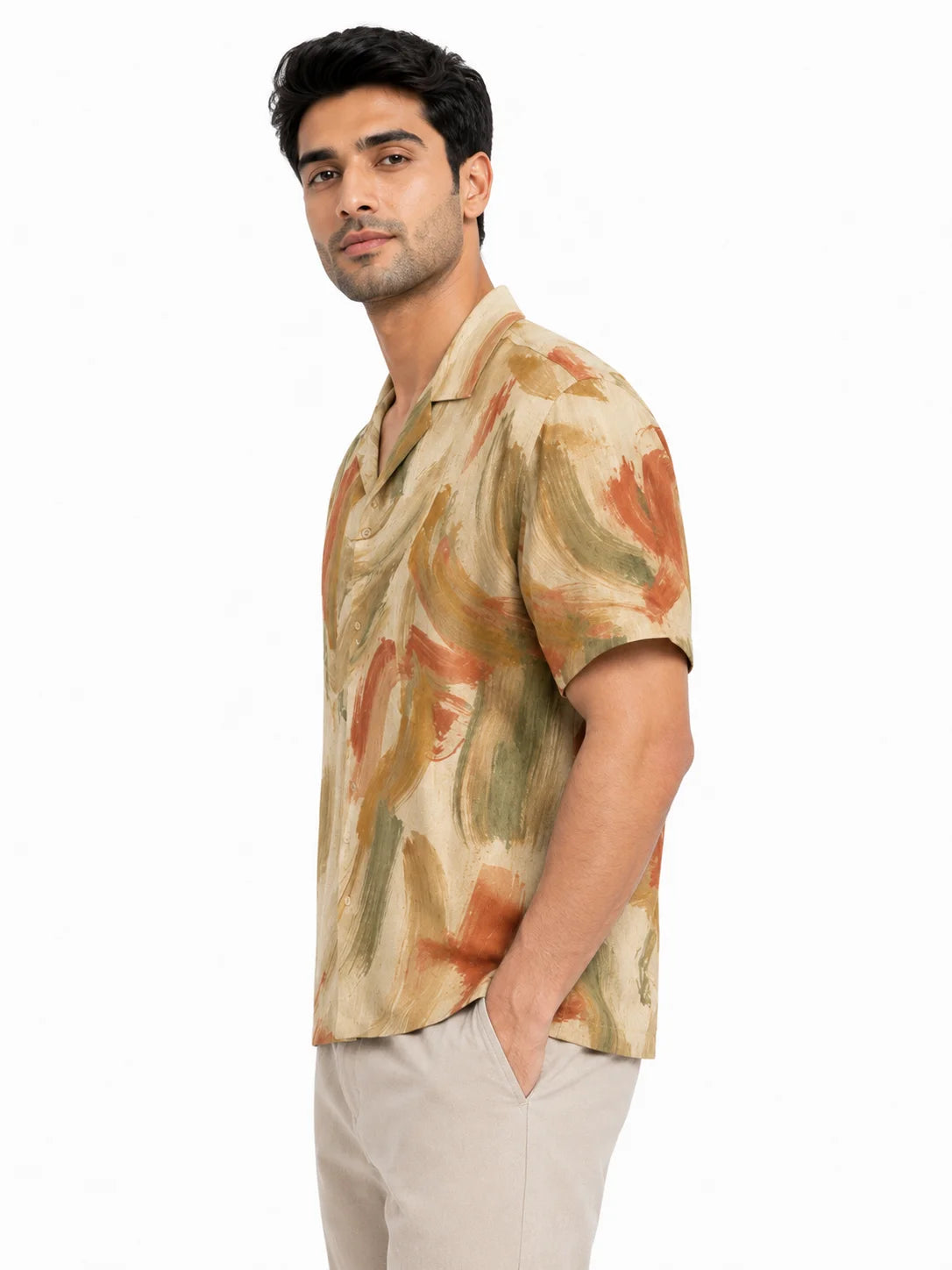 Faded Fresco linen blend camp collar shirt styled with beige trousers, left three-quarter view, abstract earth-toned print from The Soft Launch by The Edi Archive