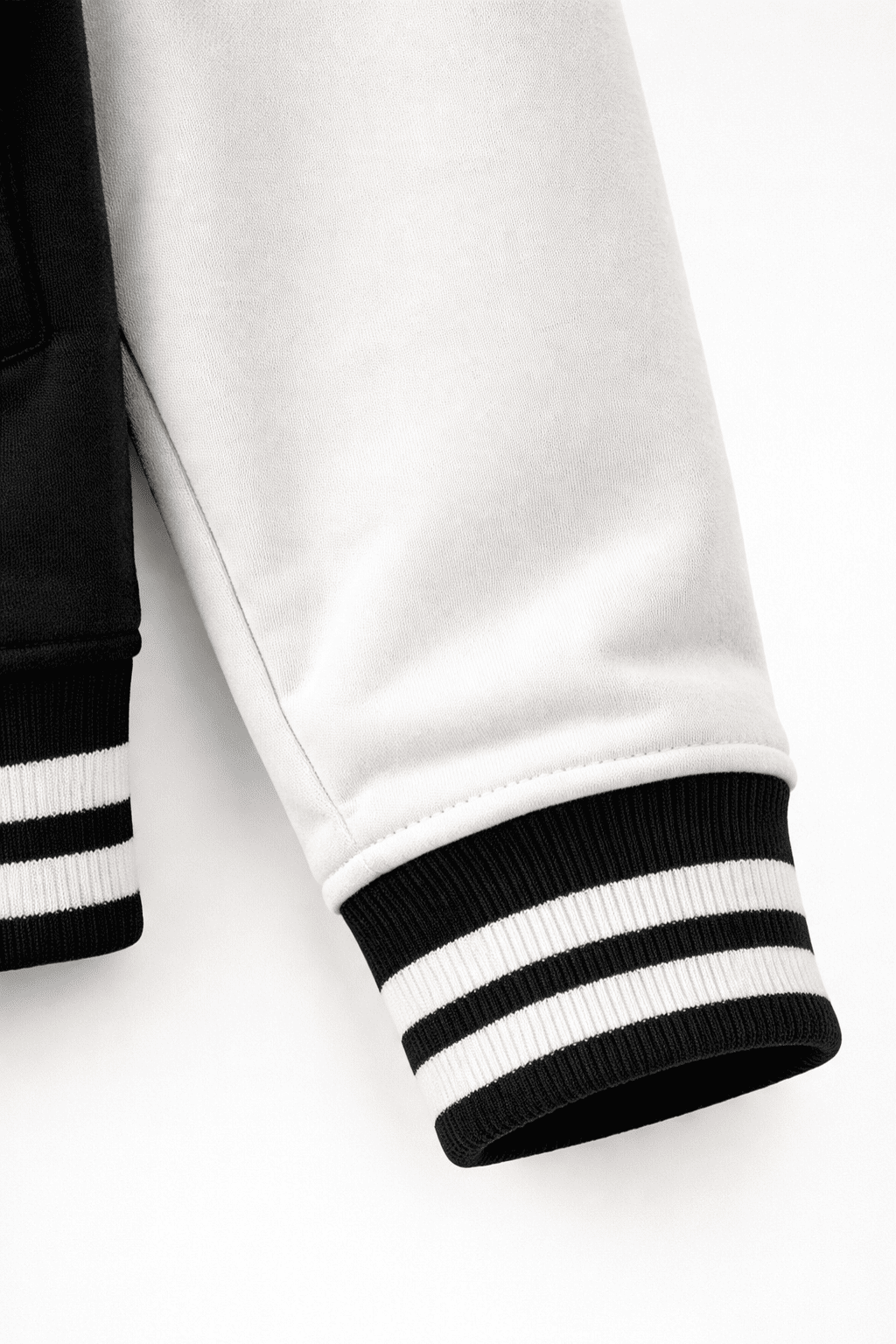 Close-up of Black Varsity jacket with black and white striped cuffs from the Custom Archive Collection from The Edi Archive