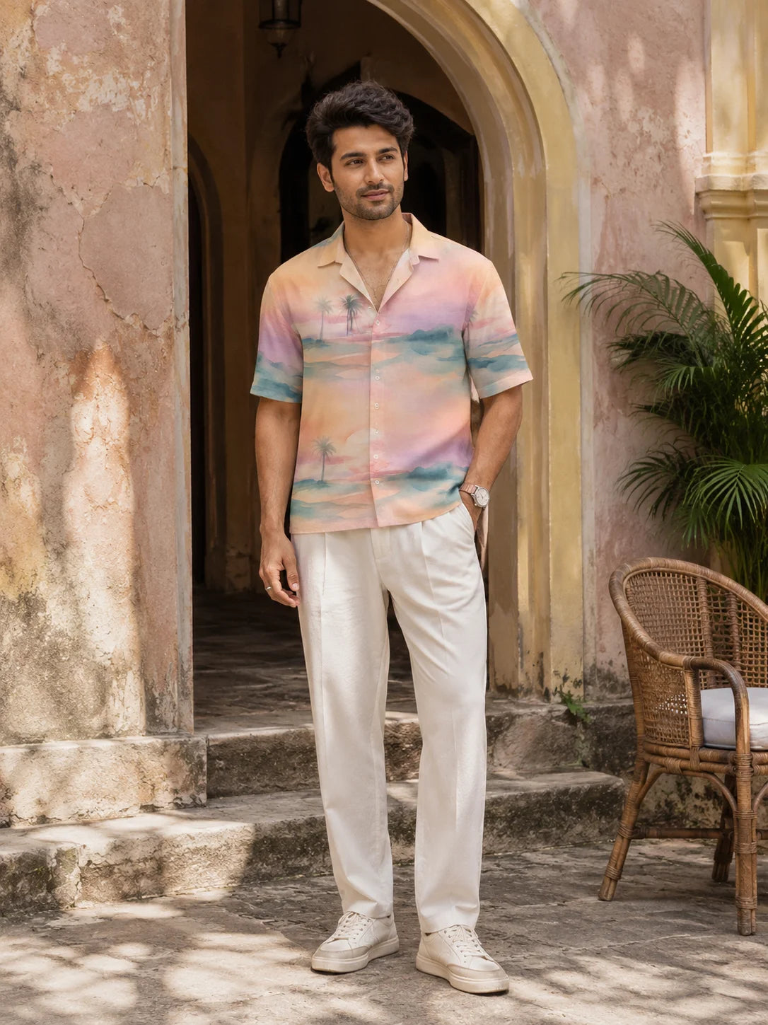Full length front view of a man in a pastel Cuban collar Hawaiian shirt styled with white trousers and sneakers, Mirage Hawaiian Shirt, Tropical Drop, The Edi Archive