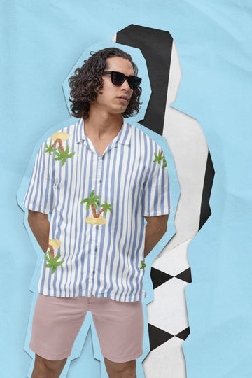 Man wearing a Nature's Paradise Men's Hawaiian Shirt from The Edi Archive, on a light blue background