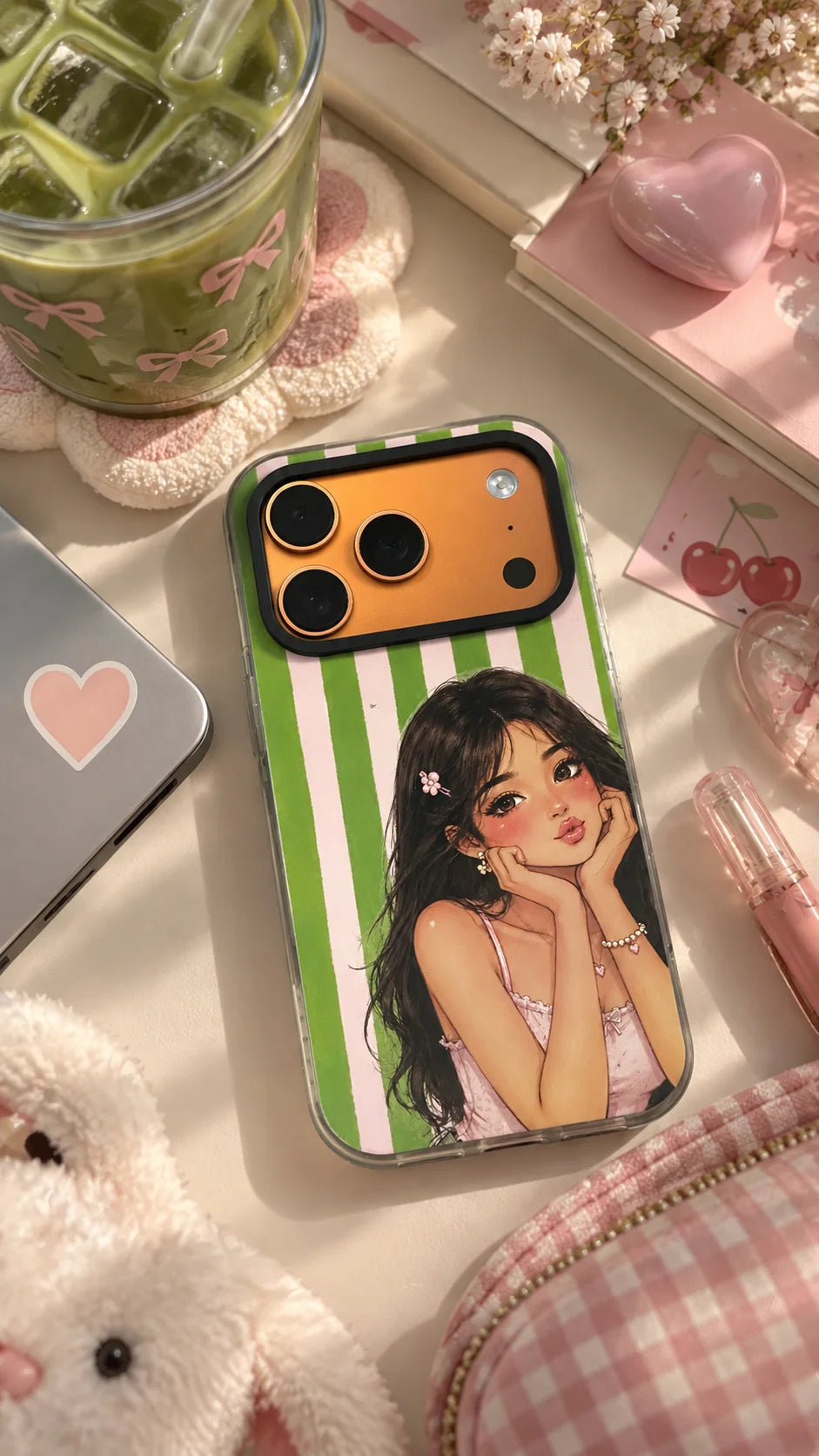 Pretty Please Hard Clear iPhone Case by The Edi Archive from The Side Quest collection, featuring a green and pink striped design with a cute illustrated girl, styled on an aesthetic desk with stationery and decor