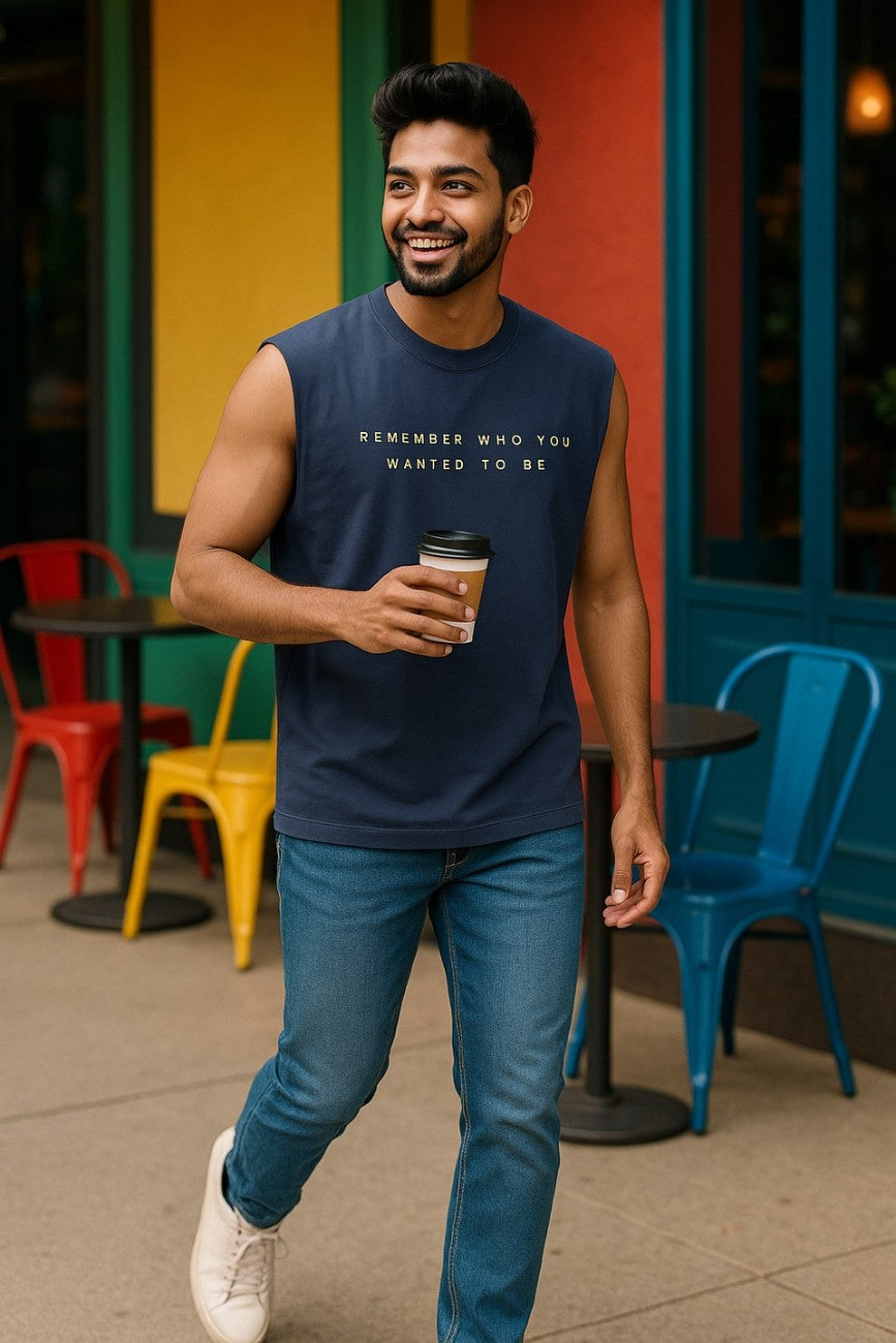 Remember Who You Wanted To Be Navy Unisex Oversized Tank Top paired with blue jeans model walking holding coffee outside colourful cafe The Edi Archive CTRL+Me Collection
