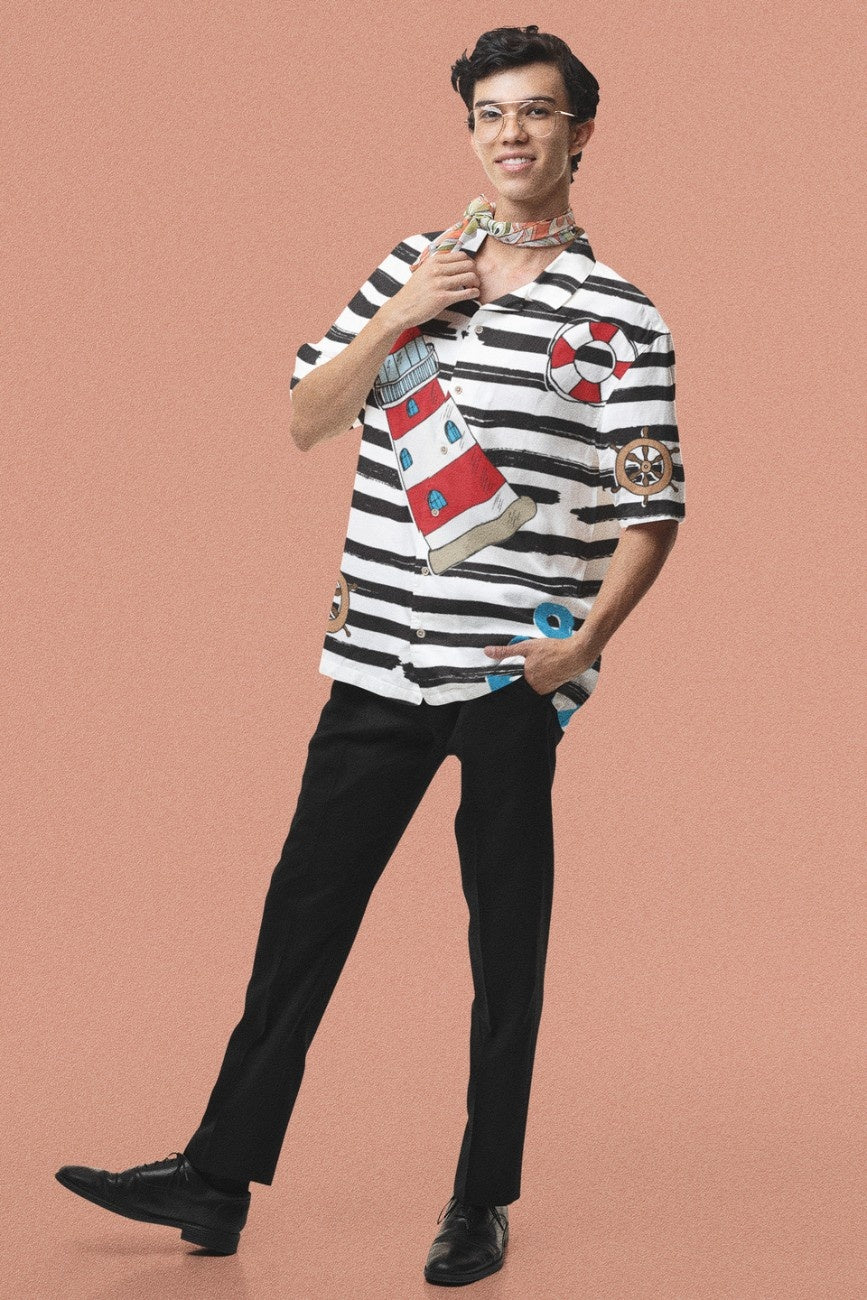 Person wearing a Sailor Colors Men's Hawaiian Shirt from the Tropical Drops Collection from The Edi Archive