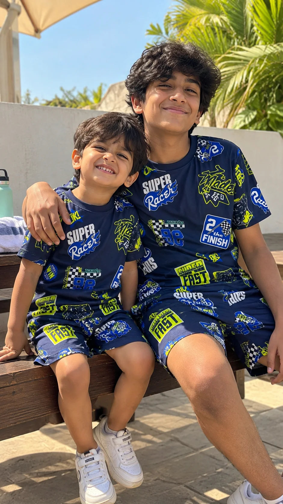 Super Racer Kids AOP Co-ord Set by The Edi Archive worn by two boys in matching racing print T-shirts and shorts