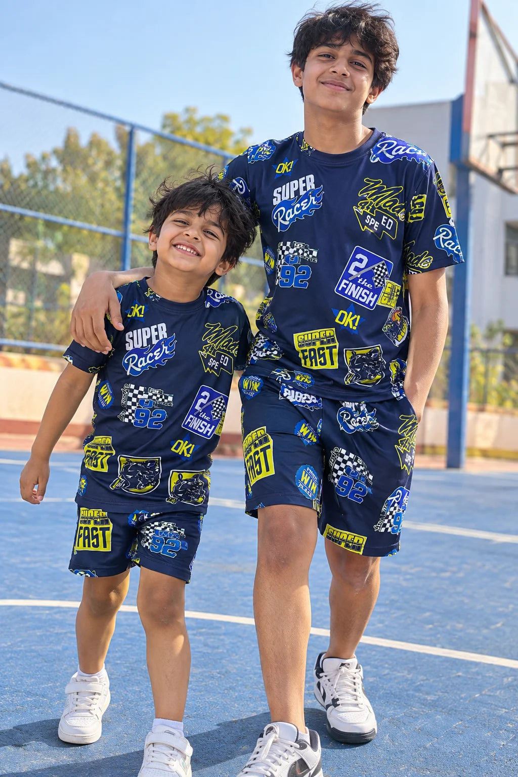 Super Racer Kids AOP Co-ord Set by The Edi Archive worn by two boys on a sports court showing the matching all-over racing print