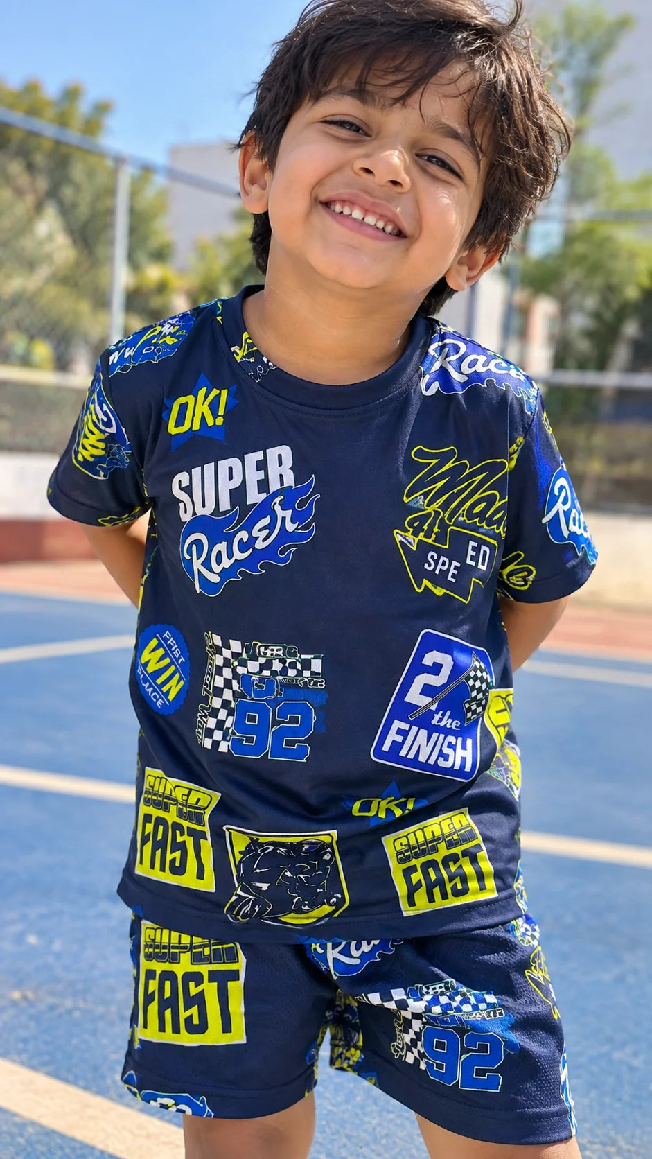 Super Racer Kids AOP T-Shirt and Sports Shorts by The Edi Archive worn by a child showing the detailed racing-inspired front print
