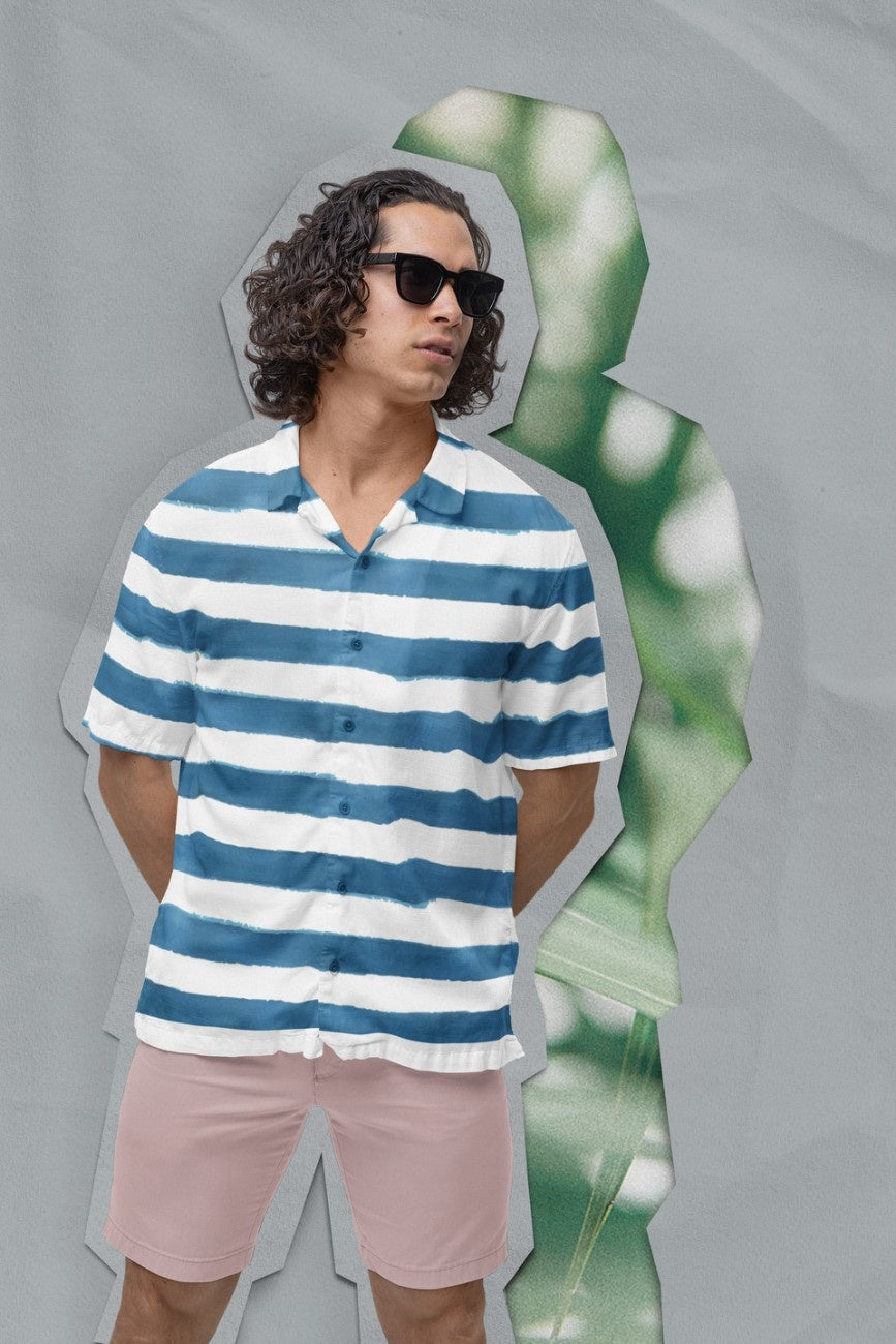Man wearing a 'Stripe the Turquoise Men's Hawaiian Shirt' from Tropical Drops Collection from The Edi Archive and pink shorts against a gray background