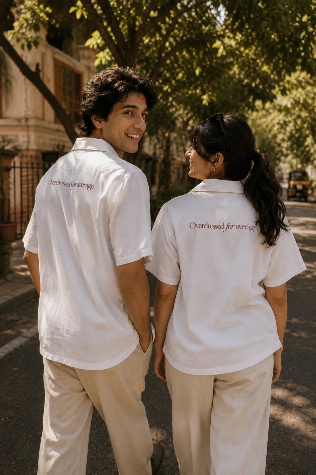 Fine Print unisex oversized cotton shirt, back view showing the Overdressed for average wine serif print, worn by two models, Ctrl+Me collection by The Edi Archive