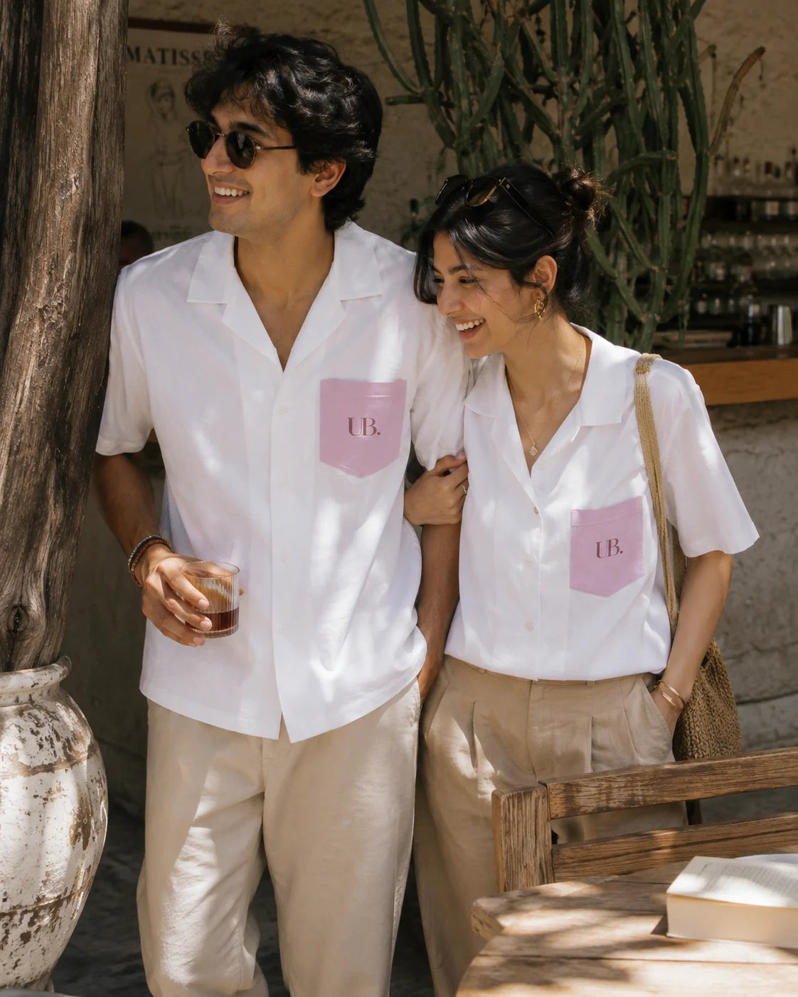 Fine Print unisex oversized camp collar shirt in white with blush UB. printed pocket, worn by a couple, from the Ctrl+Me collection by The Edi Archive