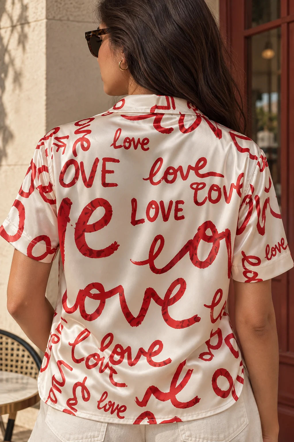 Walk The Love cream matte satin summer shirt by The Edi Archive, Soft Launch Collection, showing the back with all-over red love lettering and short sleeves