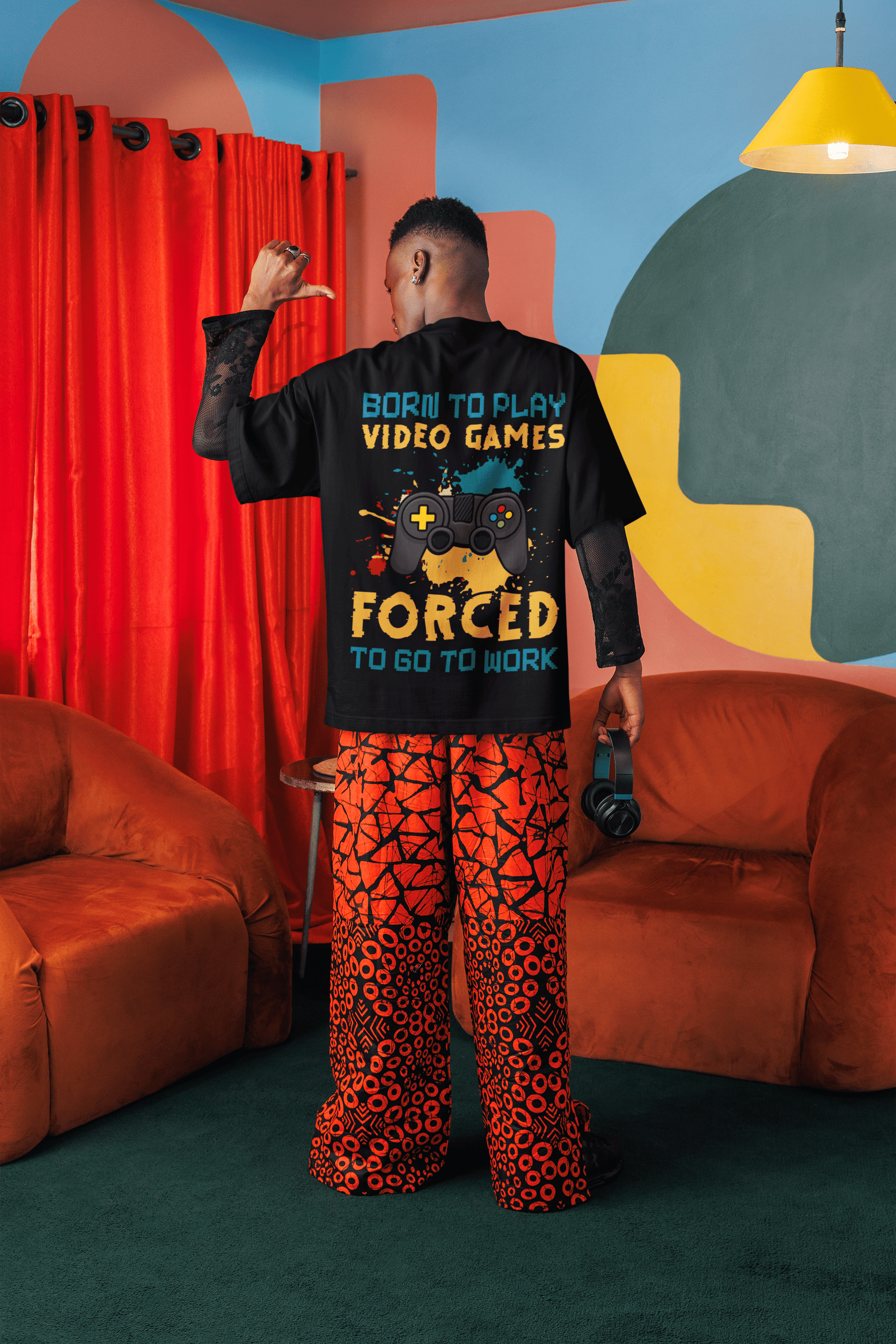 A man wearing "Born to Play Games" Oversized Unisex t-shirts from The Edi Archive huge graphics back print