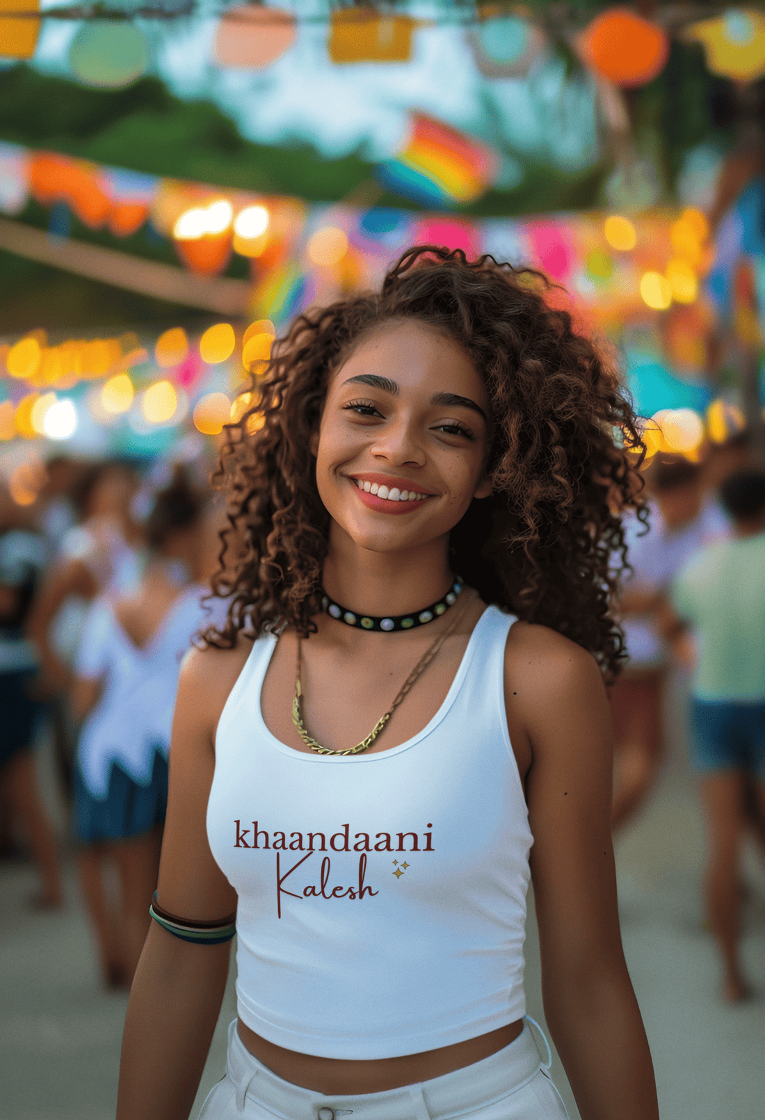Girl wearing white cotton crop tank top with bold Hindi text print that reads “Khaandaani Kalesh,” styled with playful, confident attitude.
